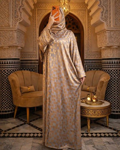Woman in a patterned dress taking a selfie in a decorative room with ornate arches and chairs.